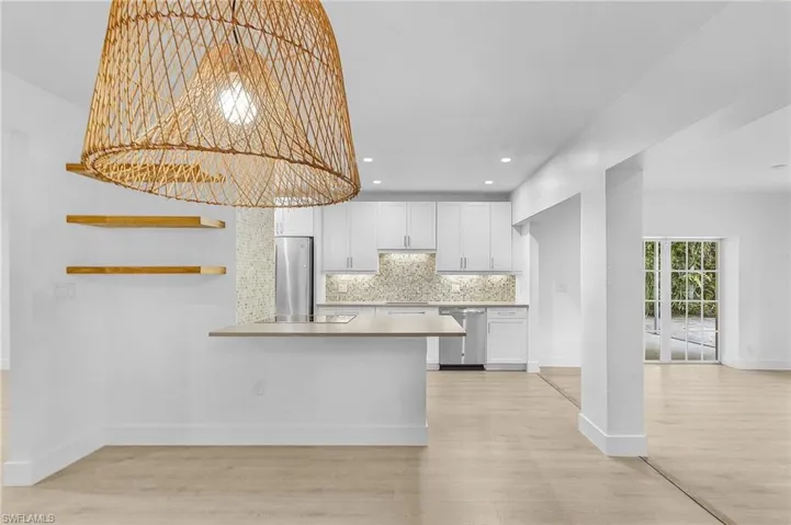 Kitchen with a breakfast counter overlooking the dinning room.