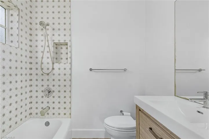 Full bath featuring vanity and shower / bath combination