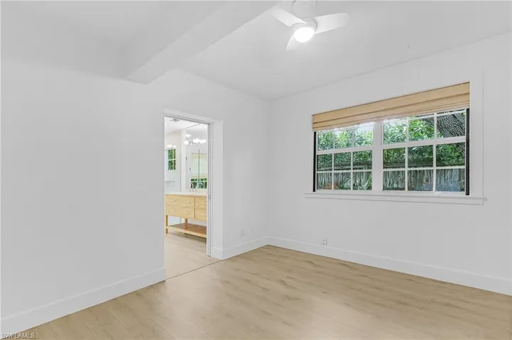 Spare room with light wood-type flooring and ceiling fan