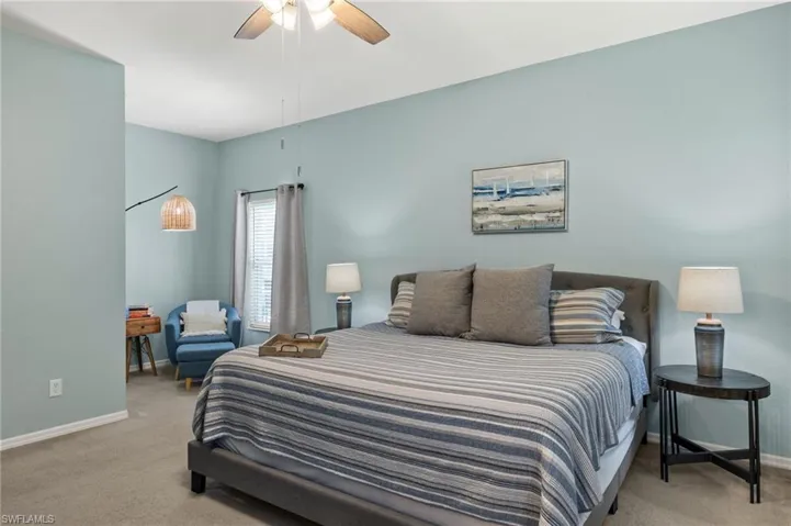 Bedroom featuring light carpet and ceiling fan