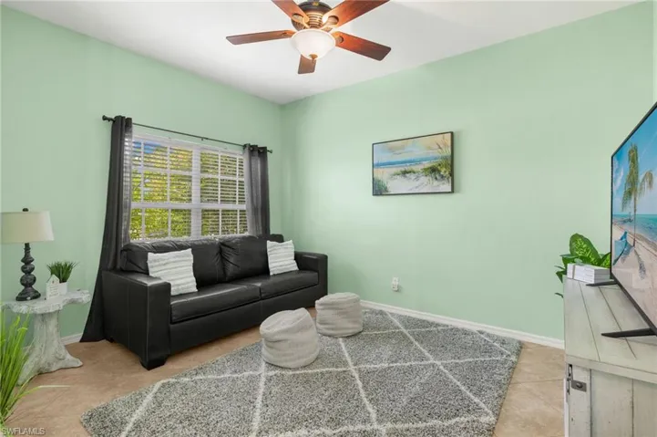 Tiled living room with ceiling fan