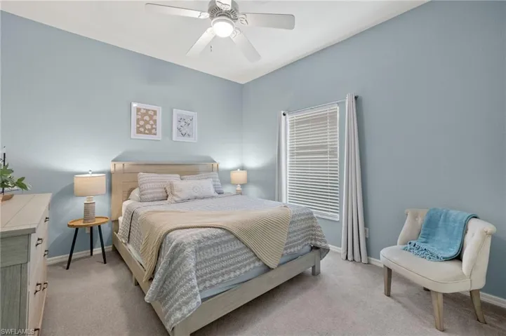 Carpeted bedroom with ceiling fan