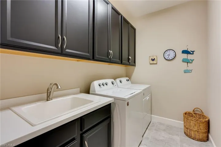 Laundry room featuring washer and dryer and cabinet space