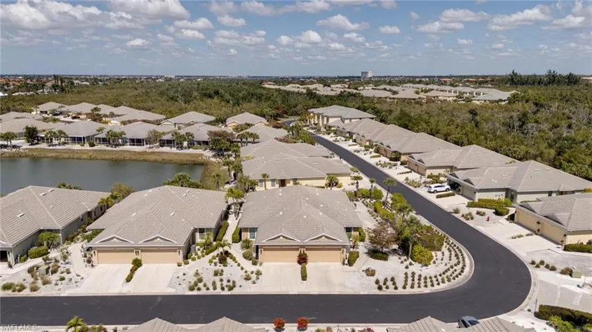 Aerial view of residential area featuring a large body of water