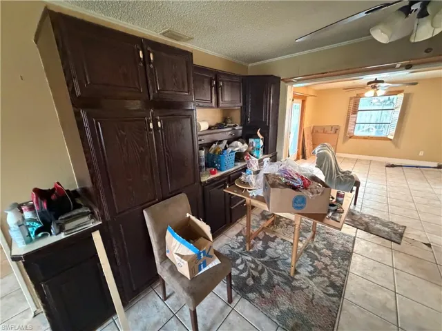 Dark wood-finish cabinetry, tile flooring, and multi-pane windows
