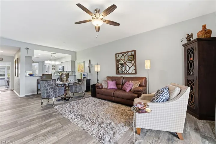 Living room featuring light wood-style flooring and a ceiling fan