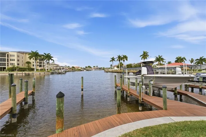 Dock featuring boat lift and a water view