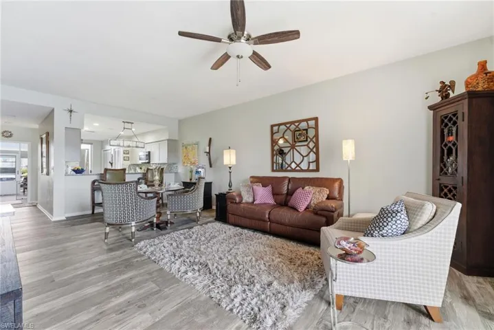 Living room with light wood-style floors and a ceiling fan