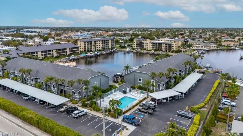 Drone / aerial view of apartment complex and a nearby body of water