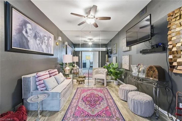 Living room featuring ceiling fan and wood finished floors