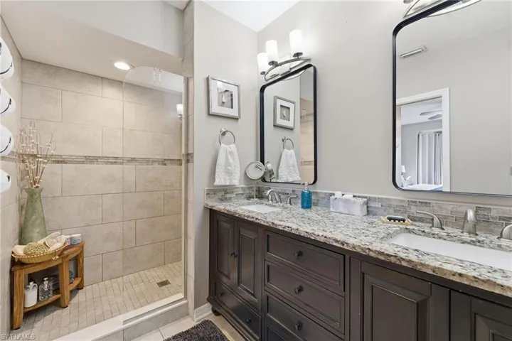 Bathroom featuring double vanity and a walk in shower