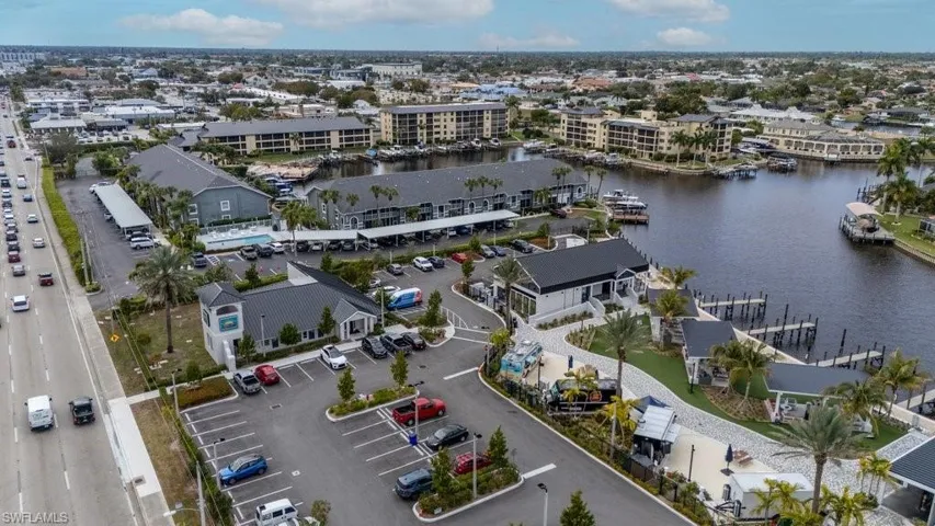 Aerial view of property and surrounding area with apartment complex and a large body of water