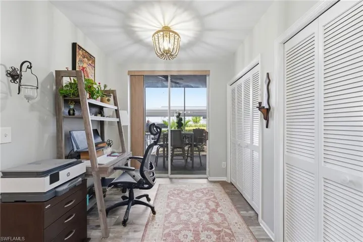 Office with a chandelier and light wood finished floors