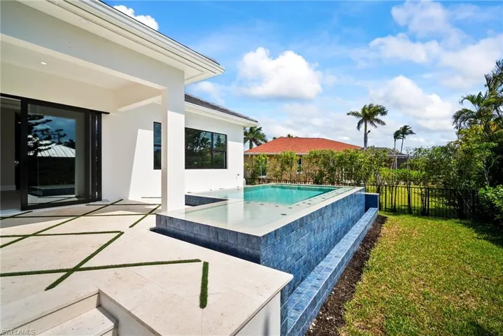 View of swimming pool with a patio and a fenced backyard