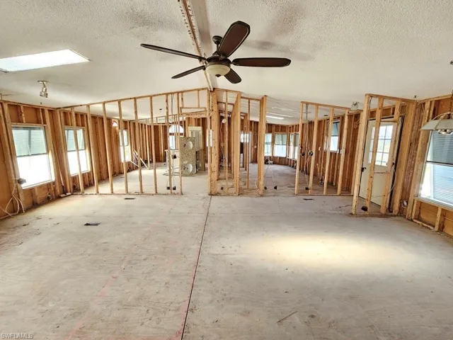 View of Great Room from hall toward kitchen and master bedroom