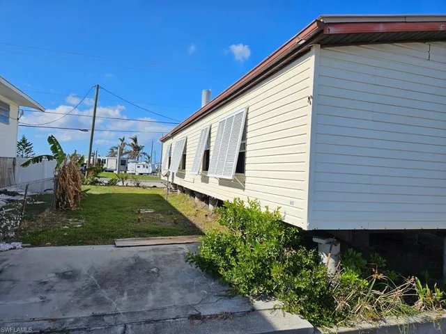View of side of property with a yard