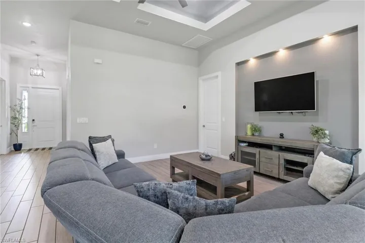Living room featuring light wood finished floors and recessed lighting