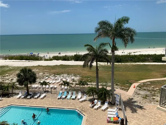 View of pool and beach , from condo balcony now
