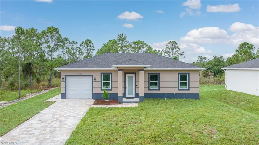 Single-story residence featuring a paved driveway, attached garage, and a charcoal shingle roof