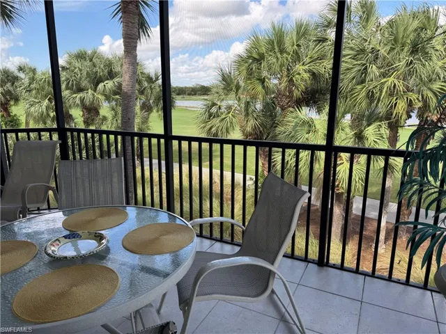 Screened outdoor living area with tile flooring and black balusters