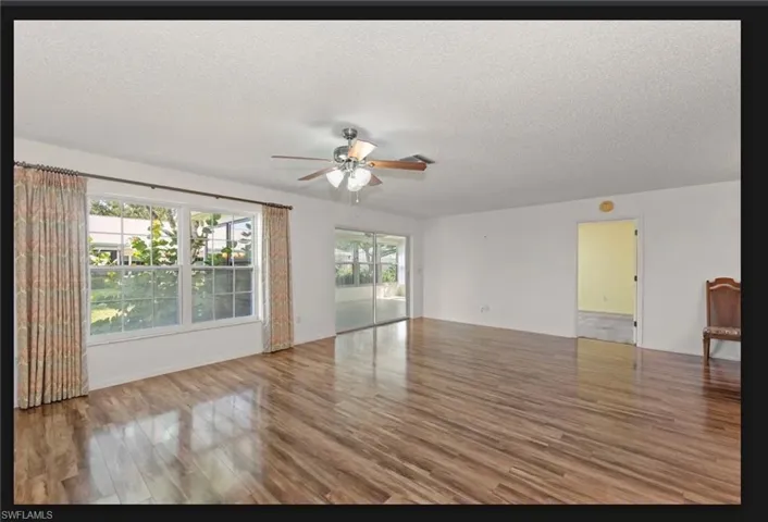 Open floor plan sliding glass doors to huge sun room