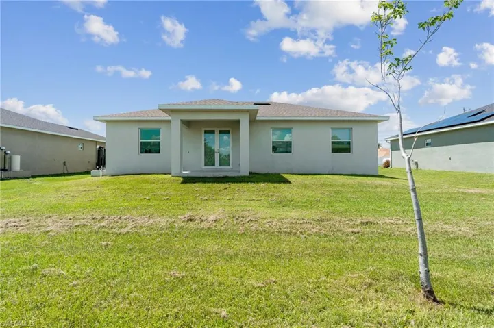Rear view of house with a lawn