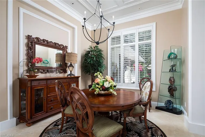 Dining room with a chandelier and ornamental molding