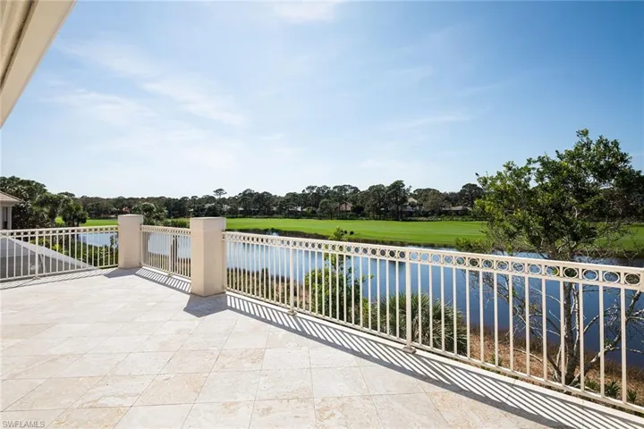 View of patio / terrace with a water view, golf course view, and view of scattered trees