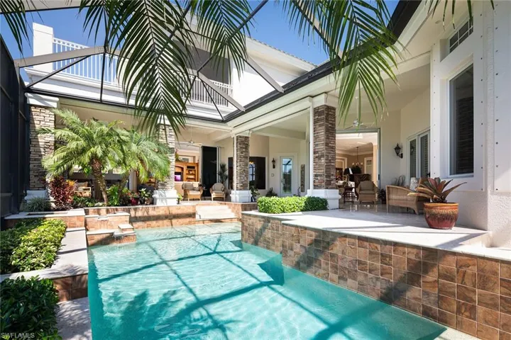 Outdoor pool with a patio, glass enclosure, outdoor furniture, and french doors