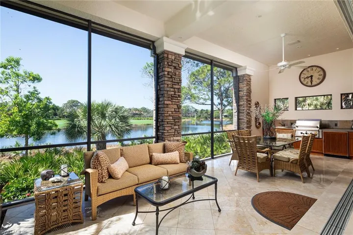 Sunroom featuring a water view
