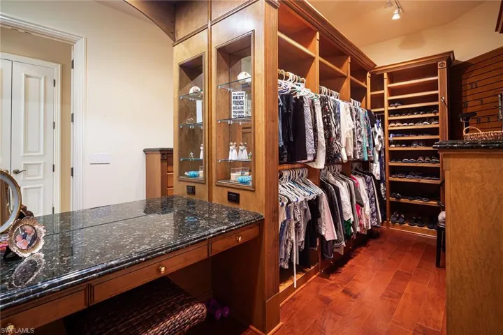 Walk in closet featuring dark wood-type flooring