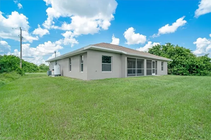 Rear view of house with a yard