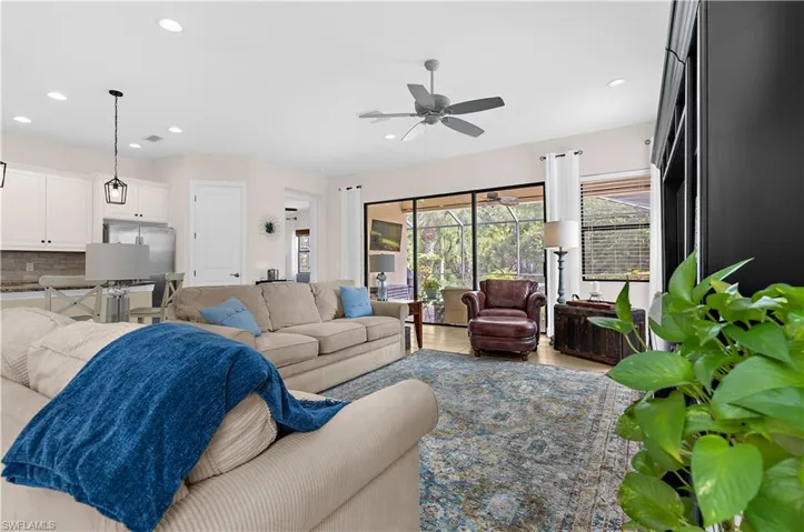 Open concept living space featuring recessed lighting, a ceiling fan, and a neutral color palette