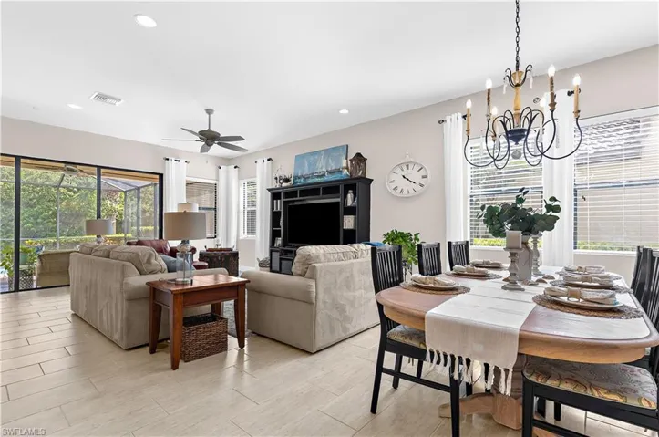 Open-concept living and dining areas featuring tile flooring, recessed lighting, and a ceiling fan