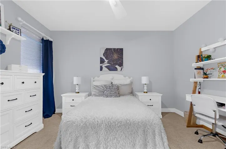 Carpeted room featuring light gray walls and white trim