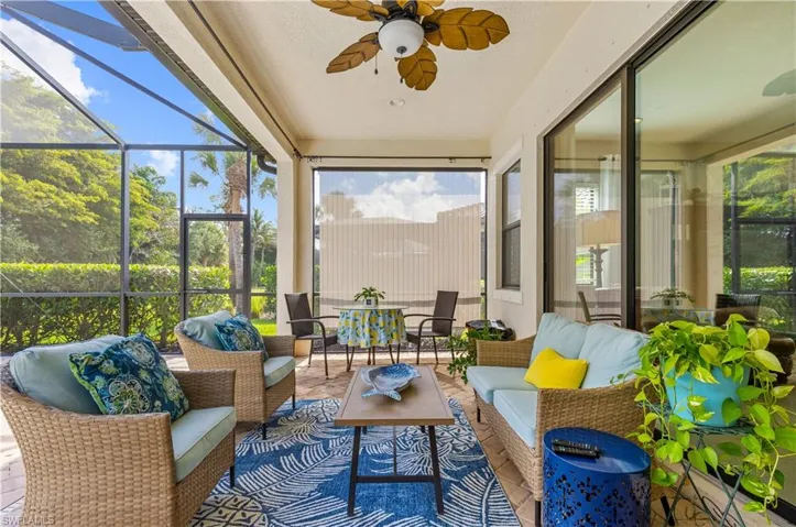Screened patio featuring a ceiling fan, sliding glass doors, and brick-finish flooring