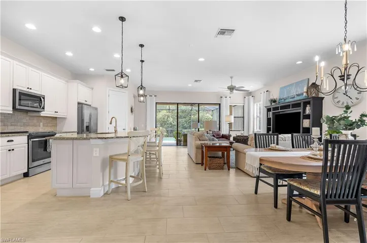 Open-concept living space featuring wood-finish flooring, recessed lighting, and a neutral color palette
