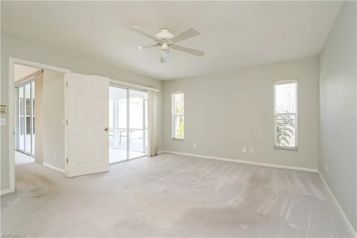 Carpeted empty room with ceiling fan