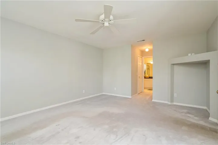 Carpeted spare room with ceiling fan
