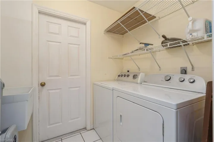 Washroom featuring separate washer and dryer and light tile patterned floors