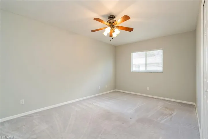 Unfurnished room with light carpet and ceiling fan
