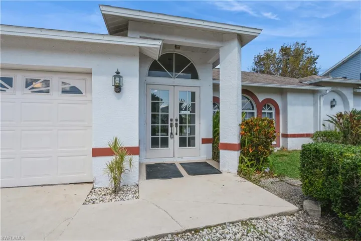 Entrance to property featuring french doors and a garage