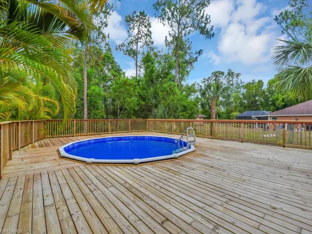 View of swimming pool with a deck