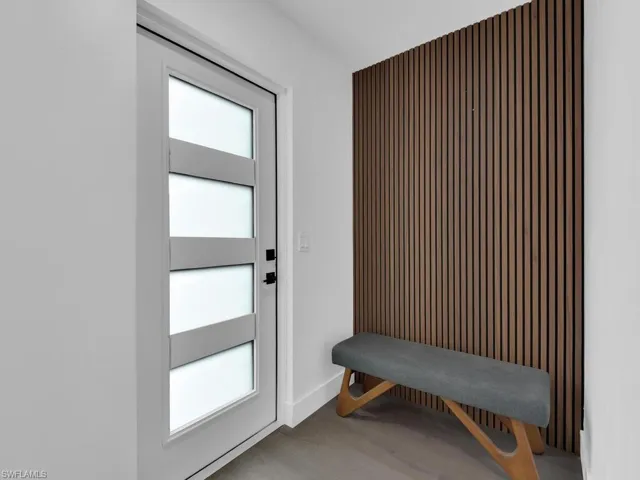 Doorway to outside featuring hardwood / wood-style flooring and plenty of natural light