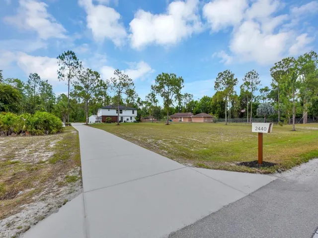 View of property's community featuring a lawn