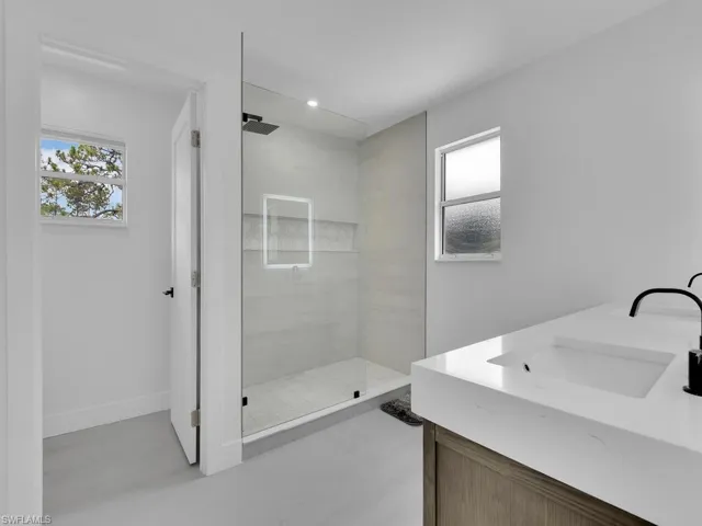 Bathroom featuring walk in shower and vanity