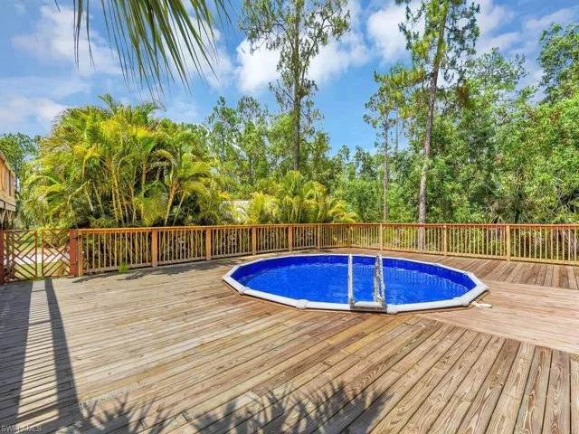 View of swimming pool with a wooden deck