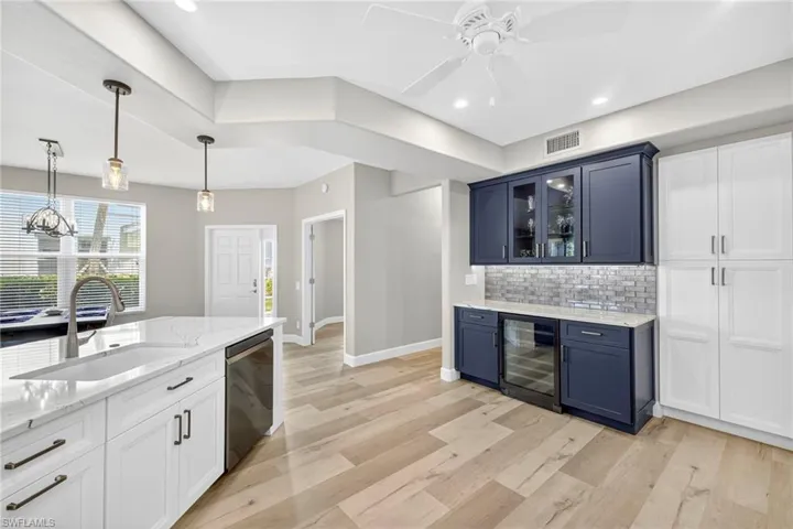 Built-in Bar with wine fridge, floor to ceiling pantry with pull outs