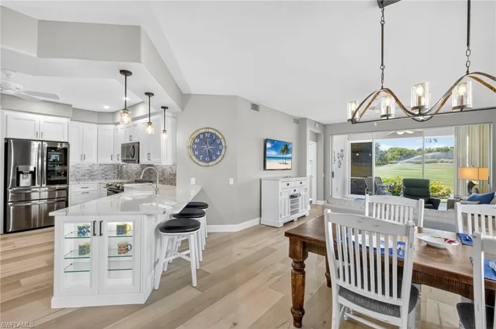 Open concept kitchen flows into the main living space with spectacular golf course views.