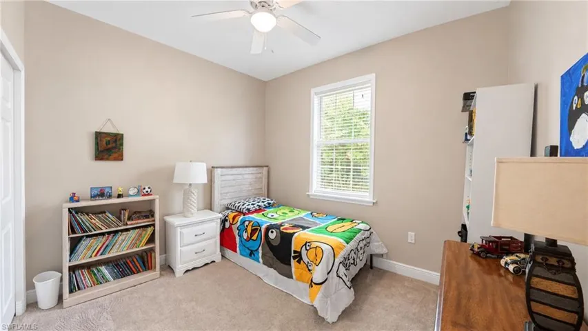 Neutral tone walls with carpeting and a window featuring blinds